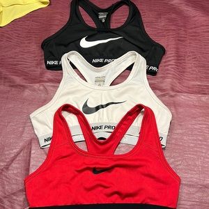 Three Nike youth sports bras
